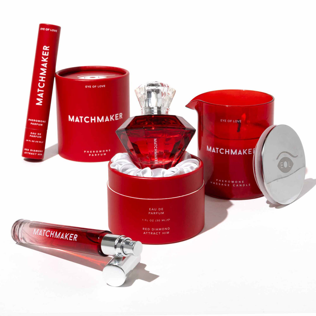 Matchmaker Red Diamond pheromone bundle featuring travel-sized perfume, perfume in a diamond-shaped bottle, scented massage candle, and packaging box.