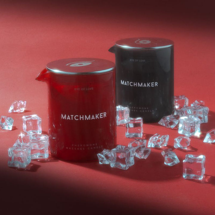 Matchmaker pheromone massage candles with silver lids surrounded by crystal ice cubes.