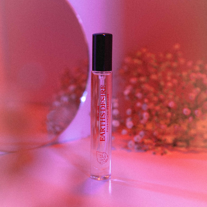 Eye of Love pheromone perfume - Earth's Desire from the Bloom collection against a neon pink backdrop
