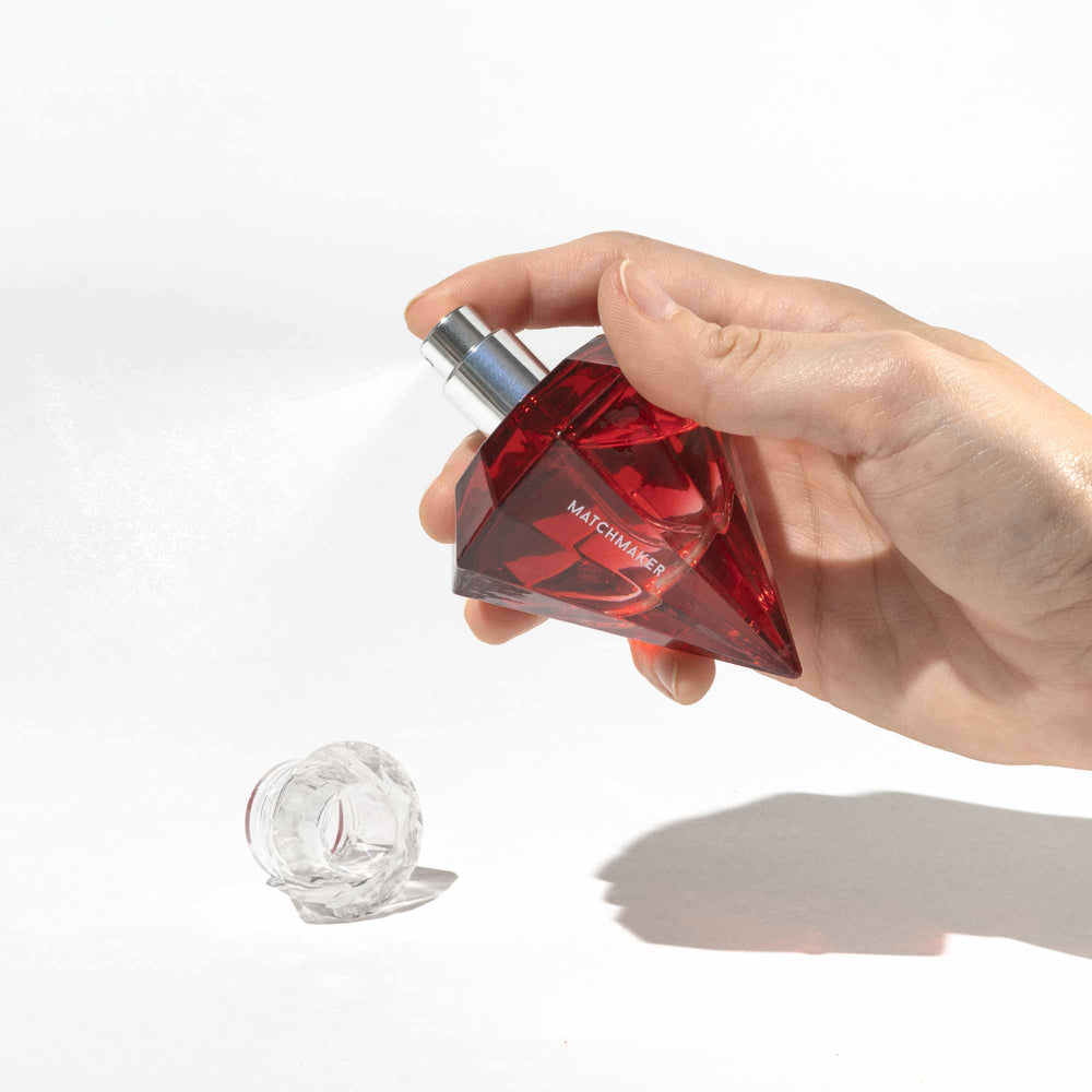 Hand holding Eye of Love Matchmaker Red Diamond pheromone parfum