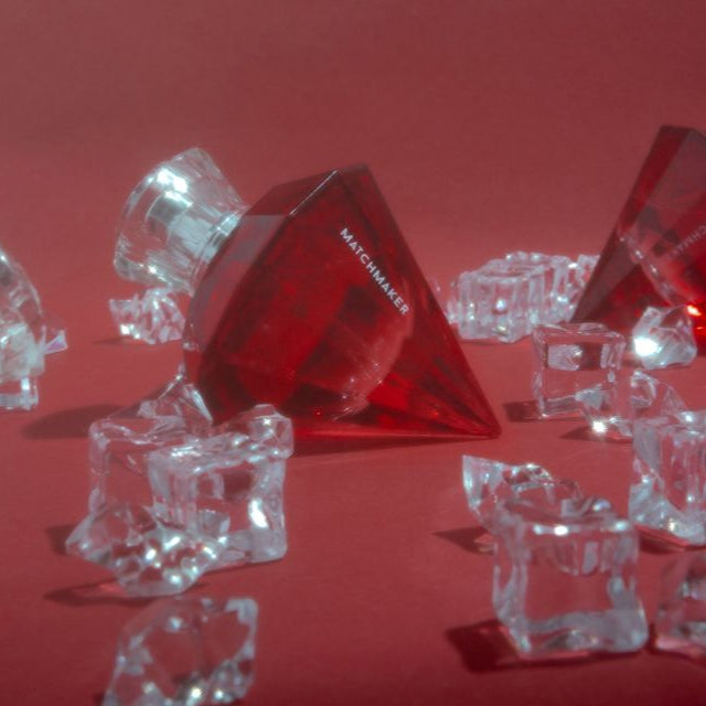 Matchmaker pheromone perfume surrounded by crystal ice cubes.