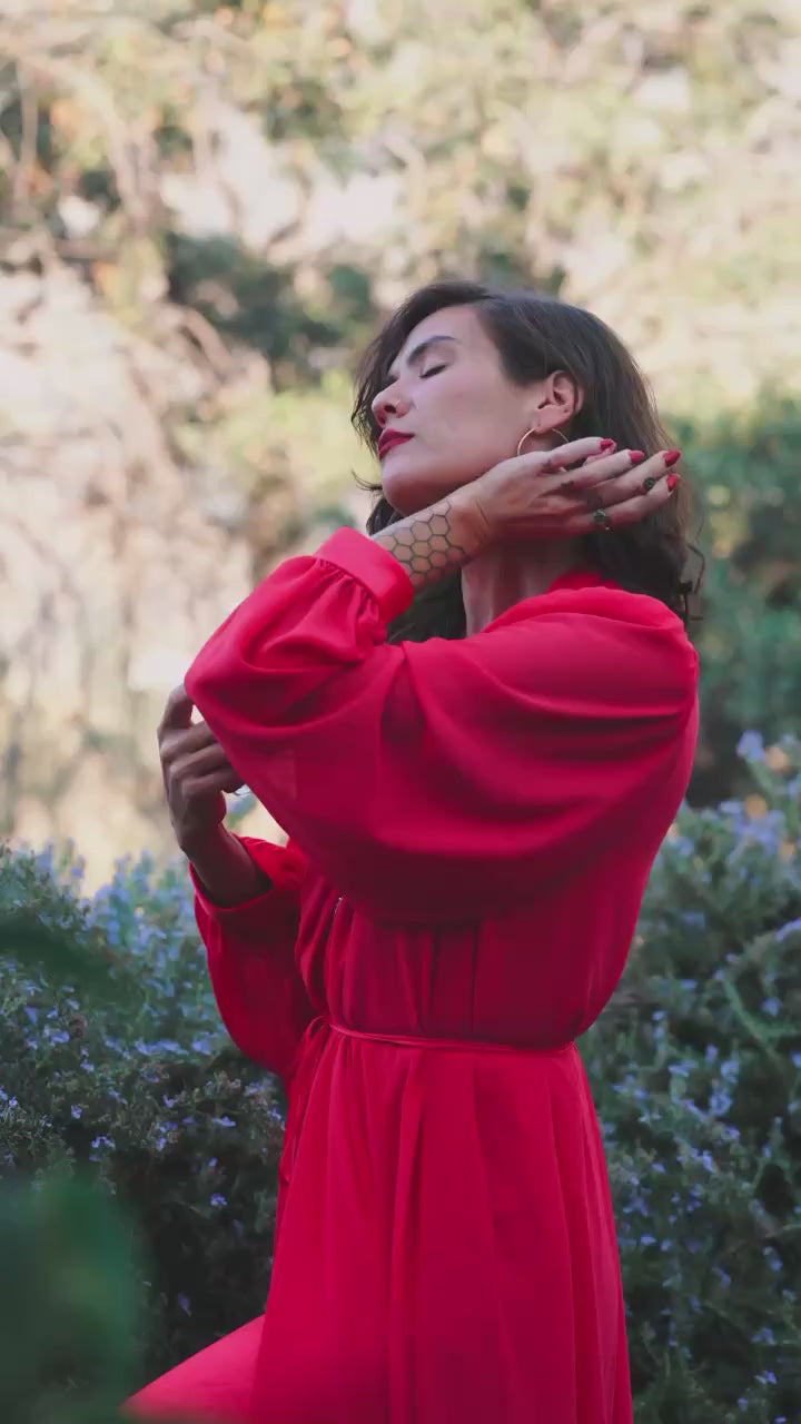 Video showing a girl in a red dress spritzing herself with Eye of Love pheromone perfume